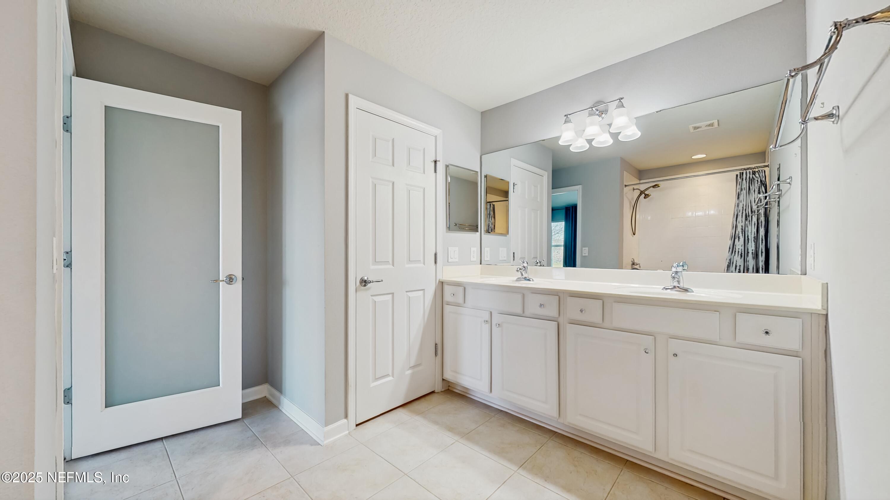 7030 Roundleaf Drive Jacksonville, FL 32258 - Photo 8 of 39 a spacious bathroom with a granite countertop sink mirror and