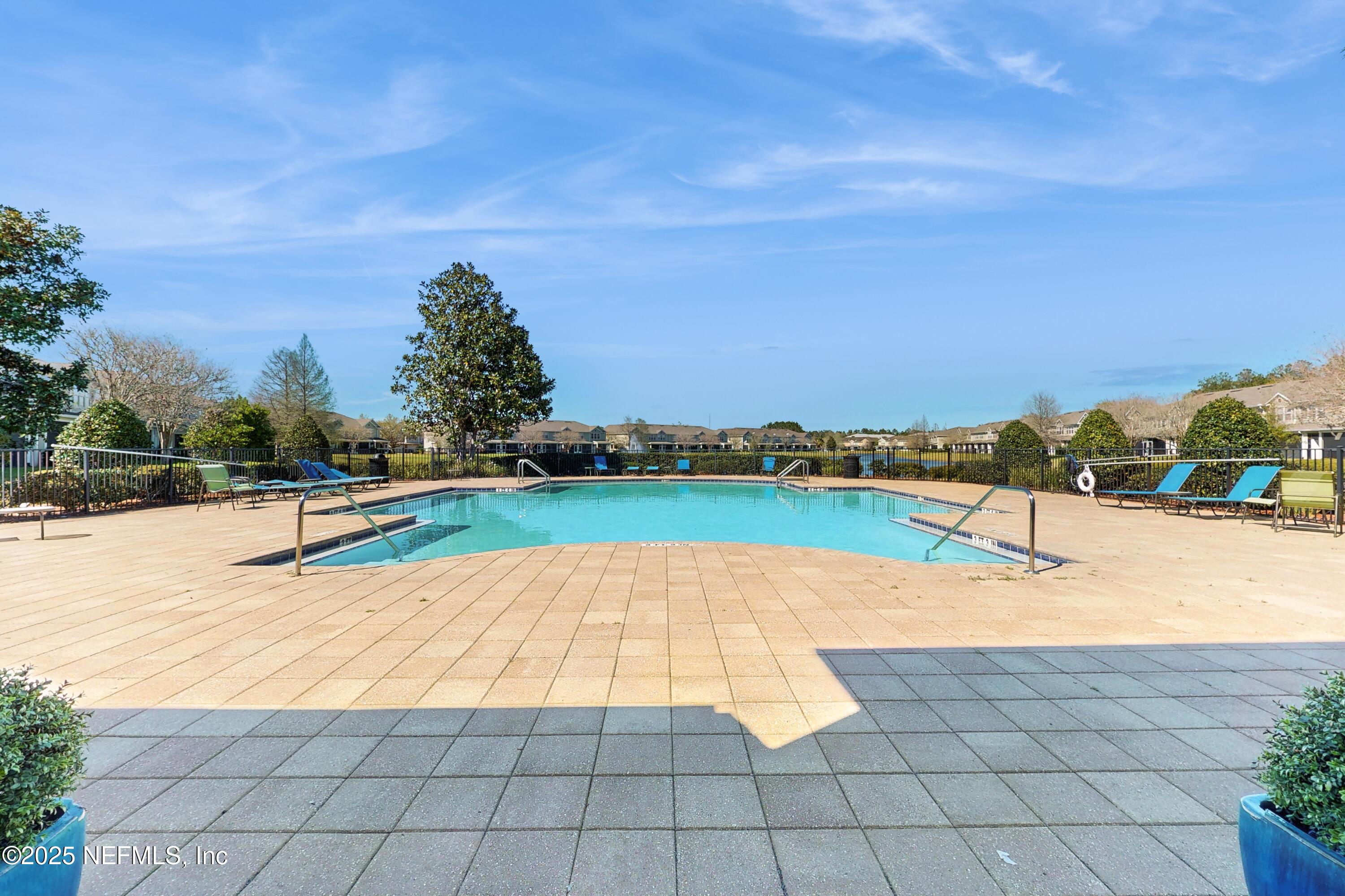 7030 Roundleaf Drive Jacksonville, FL 32258 - Photo 9 of 39 a view of swimming pool with seating area and trees in the background