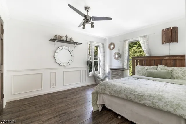 a bedroom with a beds and a chandelier