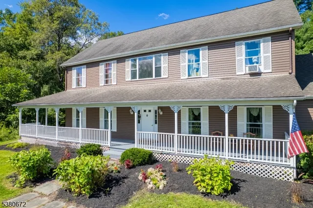 a view of a house with swimming pool in front of it