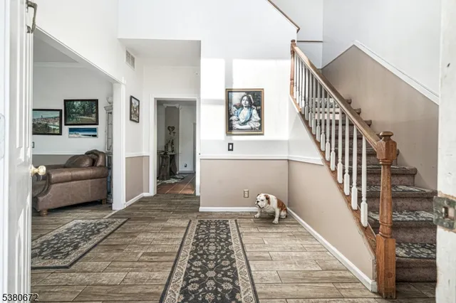 a dining room with furniture a chandelier and wooden floor