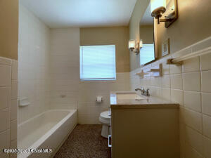 317 3rd Avenue Indialantic, FL 32903 - Photo 8 of 18 a bathroom with a sink toilet and shower