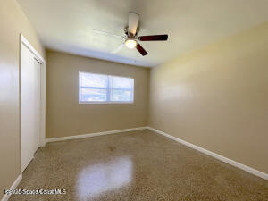 317 3rd Avenue Indialantic, FL 32903 - Photo 9 of 18 an empty room with windows and fan