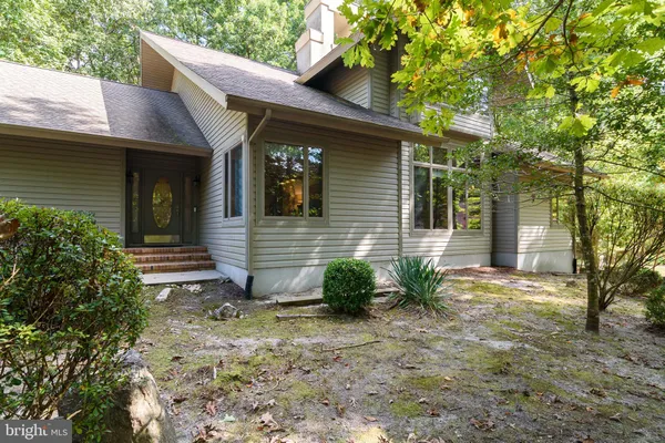 a view of house with backyard space and garden