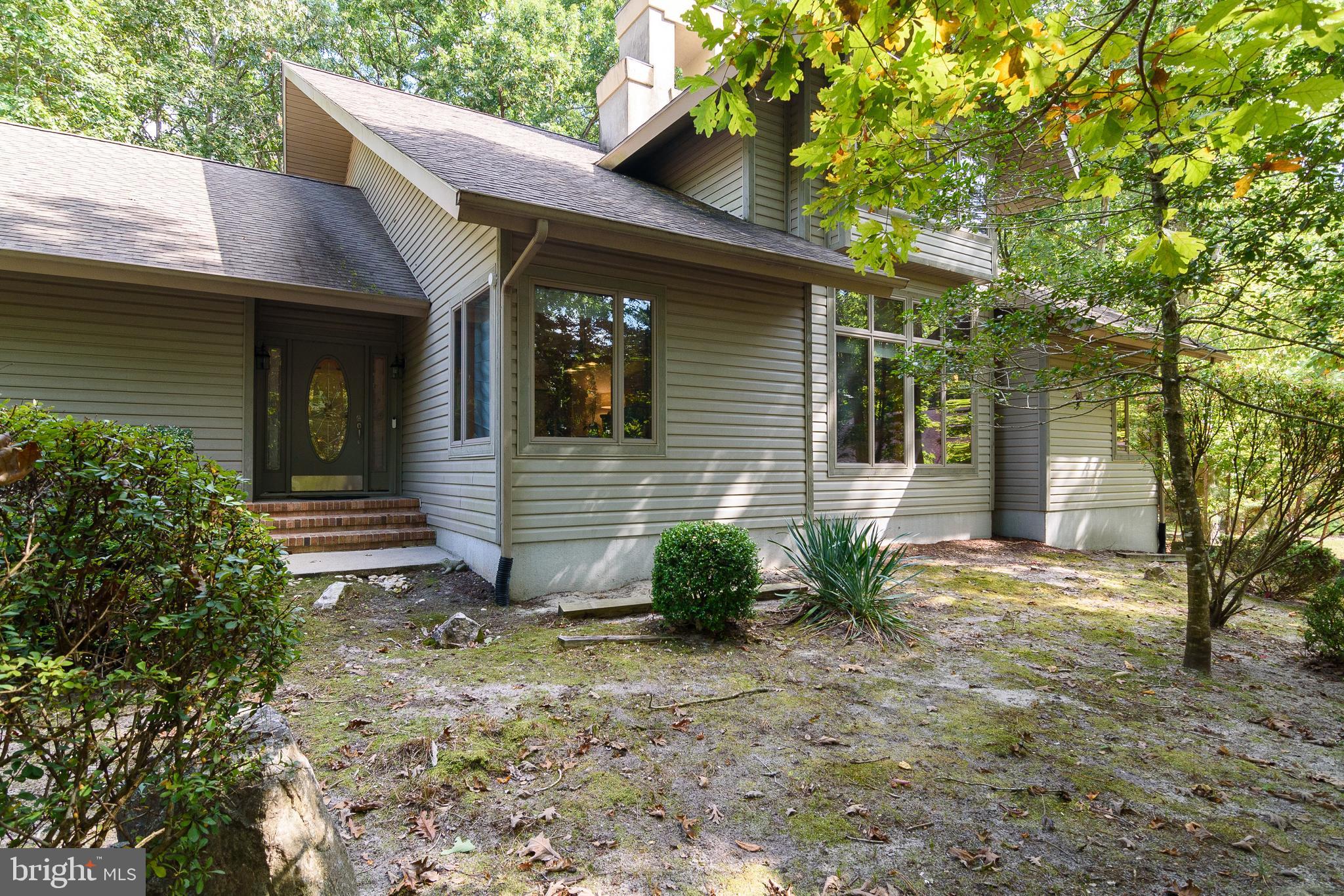 a view of house with backyard space and garden
