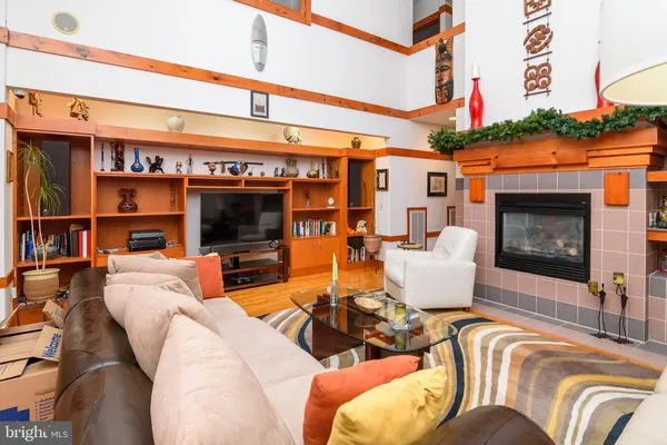 a living room with furniture a flat screen tv and a fireplace