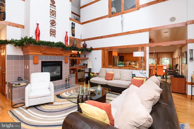 a view of a patio with couches chairs and a fireplace