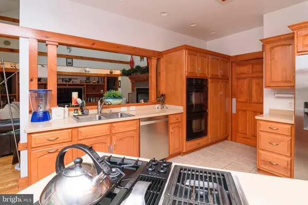 a kitchen with stainless steel appliances granite countertop a refrigerator and a stove top oven