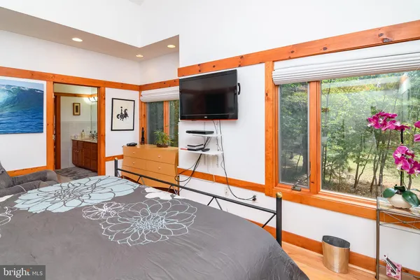 a living room with a flat screen tv and a floor to ceiling window