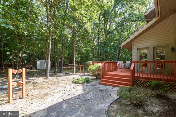 a view of backyard with deck and chairs