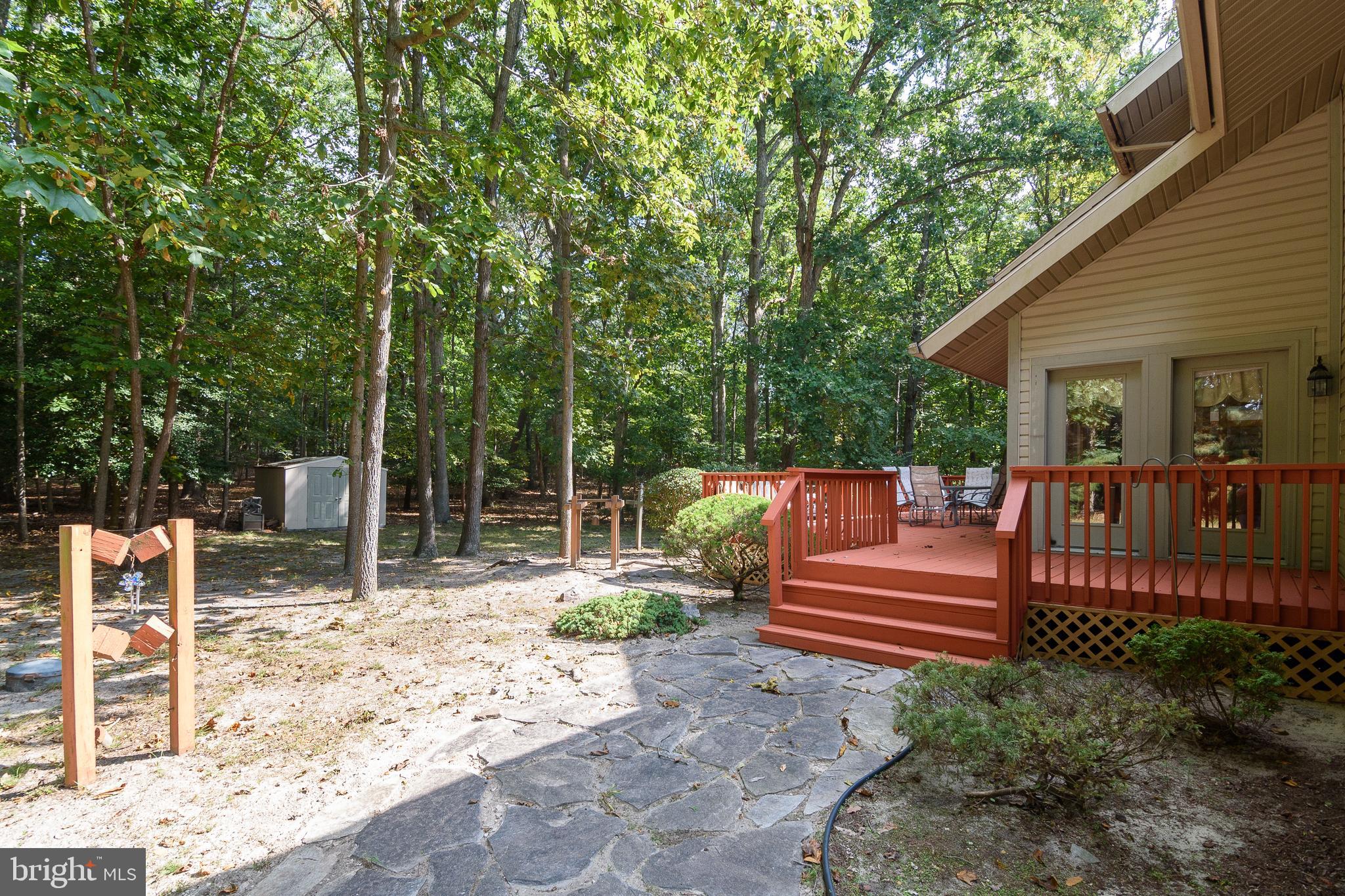 23615 Quail Hollow Circle Lewes, DE 19958 - Photo 3 of 49 a view of backyard with deck and chairs