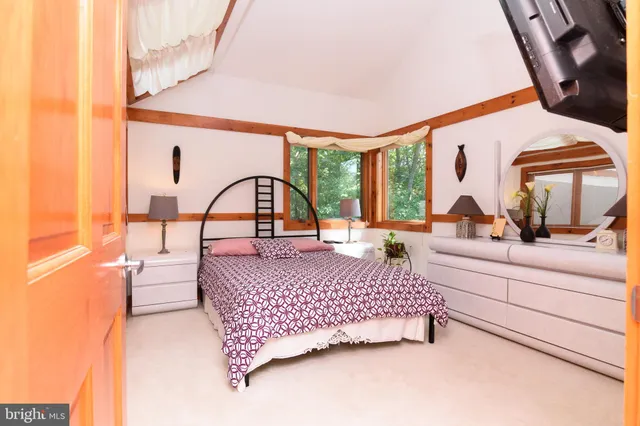 a living room with a bed furniture and a large window