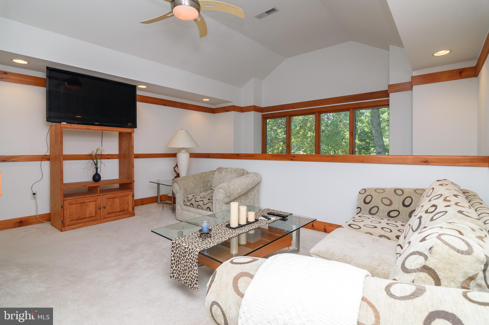 23615 Quail Hollow Circle Lewes, DE 19958 - Photo 40 of 49 a bedroom with furniture and a flat screen tv