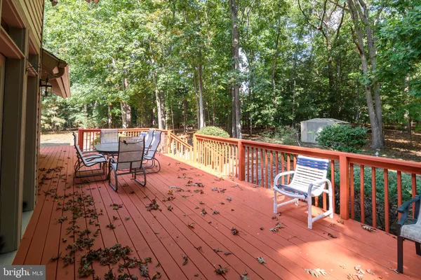 a balcony with wooden floor and outdoor seating