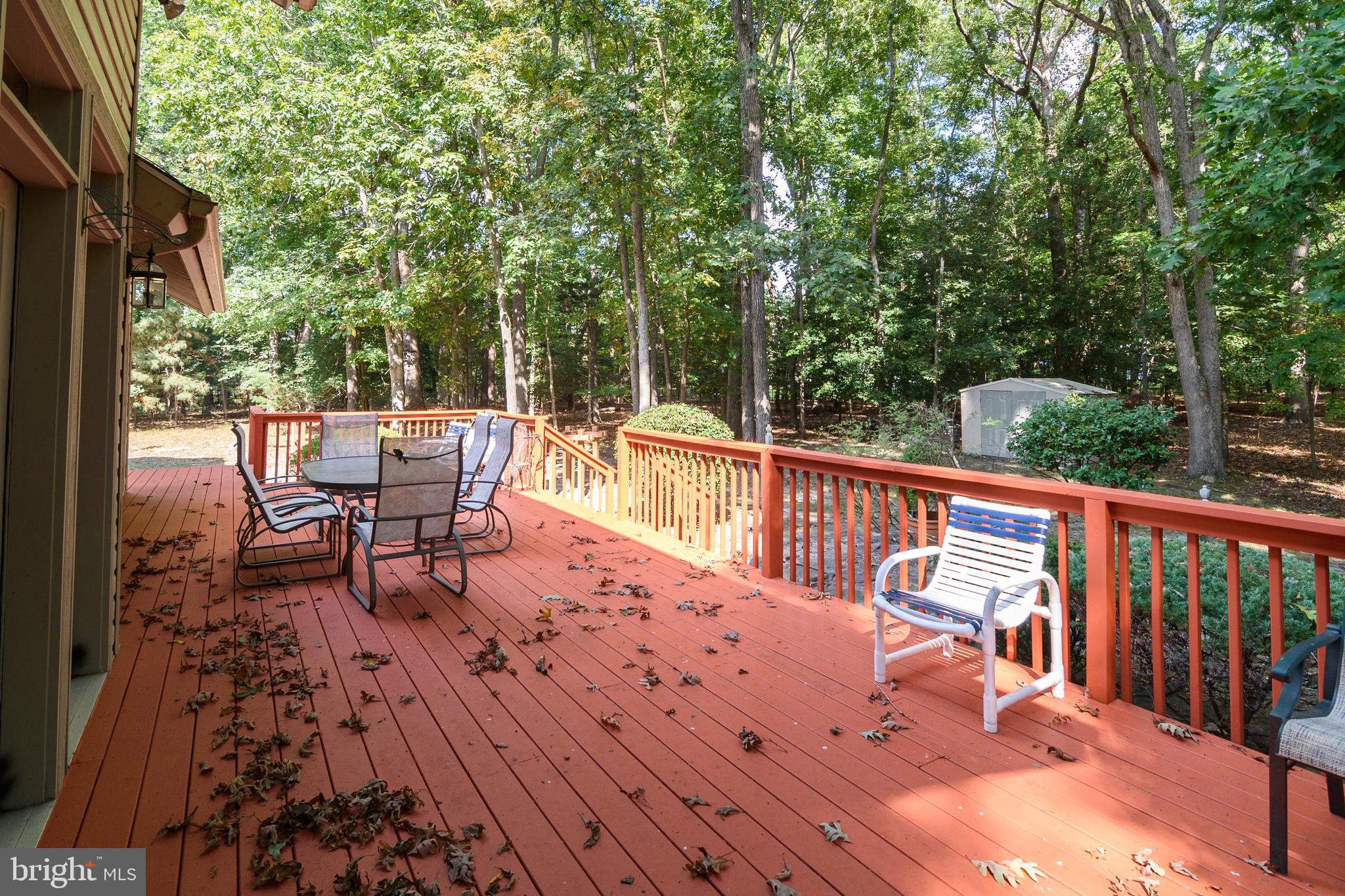 23615 Quail Hollow Circle Lewes, DE 19958 - Photo 5 of 49 a balcony with wooden floor and outdoor seating