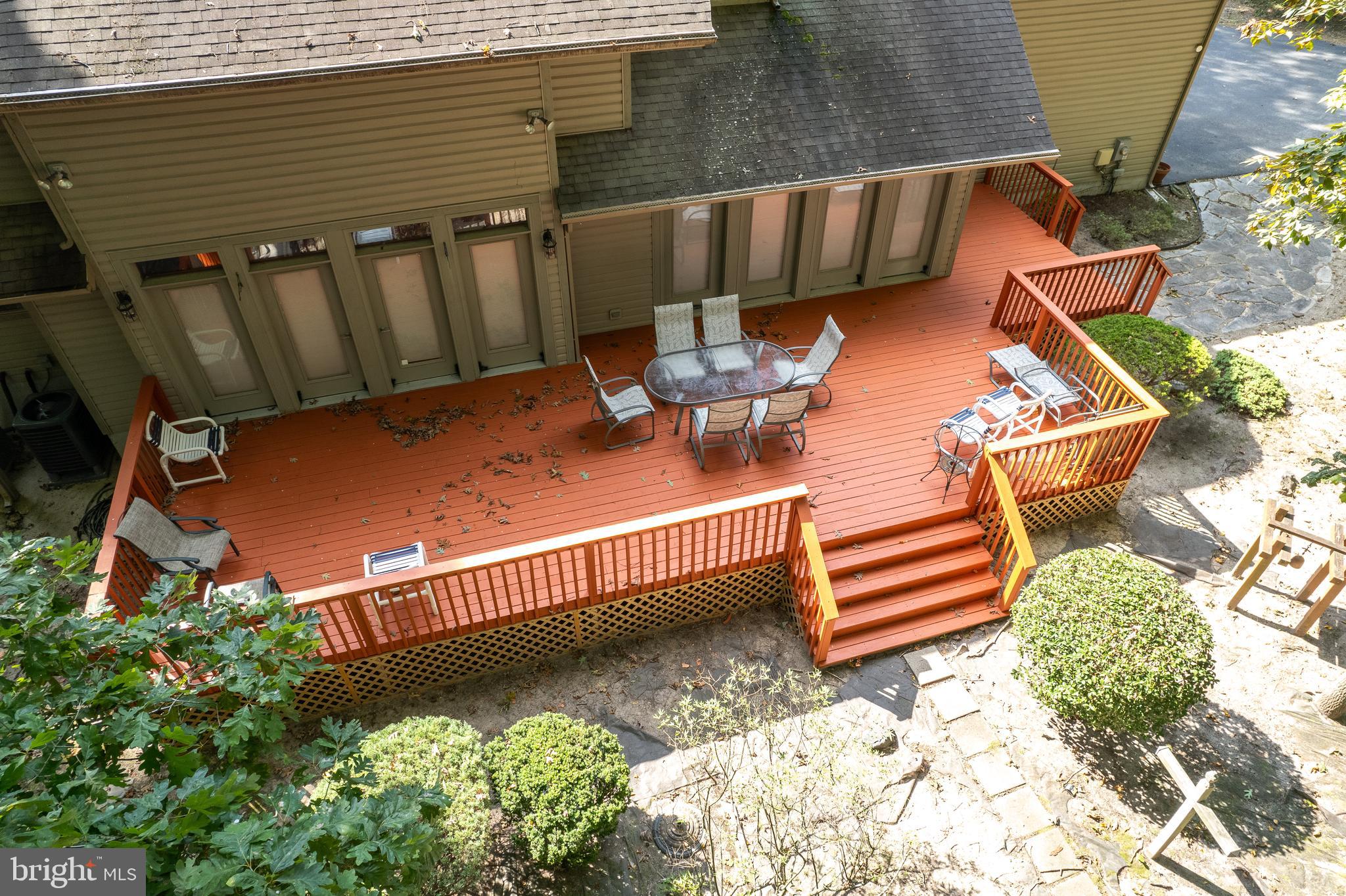 23615 Quail Hollow Circle Lewes, DE 19958 - Photo 6 of 49 a view of a deck with a table and chairs with wooden fence