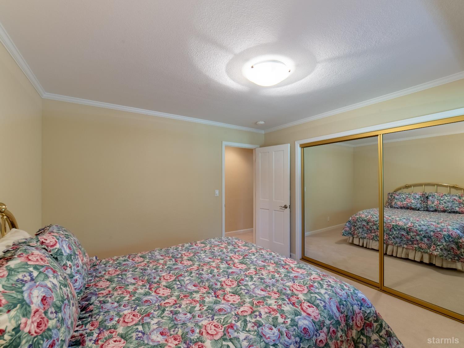214 Uplands Way South Lake Tahoe, CA 96150 - Photo 13 of 27 a bedroom with a bed and a mirror