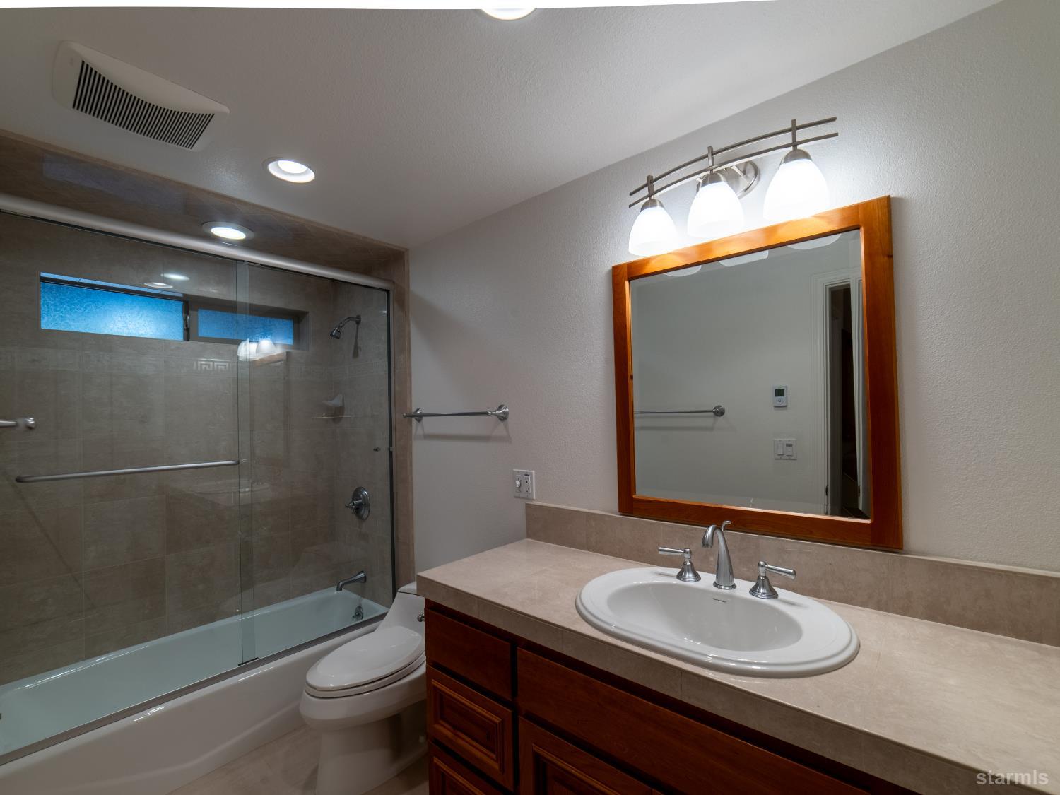 214 Uplands Way South Lake Tahoe, CA 96150 - Photo 15 of 27 a bathroom with a sink and a mirror