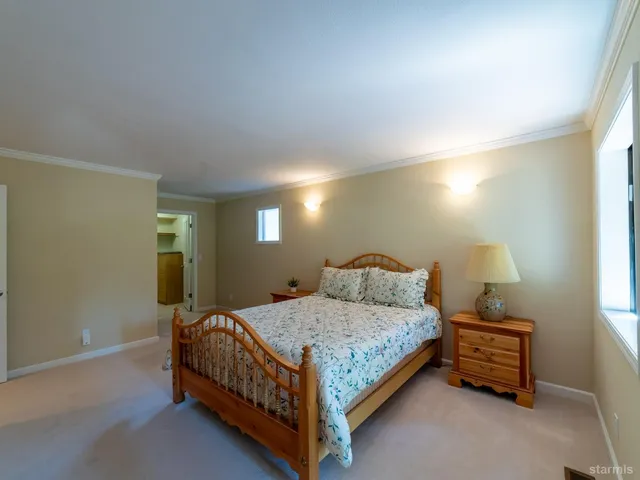 a bedroom with a bed and a night stand