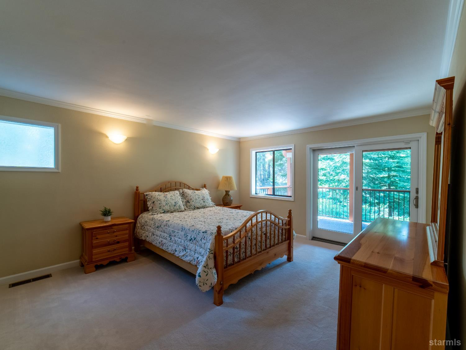 214 Uplands Way South Lake Tahoe, CA 96150 - Photo 19 of 27 a bedroom with a bed and a lamp next to a window