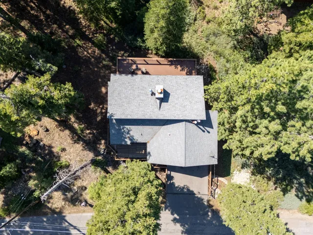 an aerial view of a house with a yard and sitting area