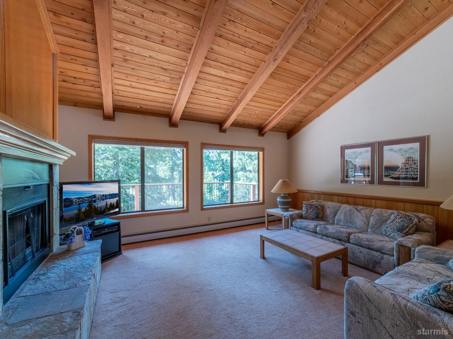 214 Uplands Way South Lake Tahoe, CA 96150 - Photo 7 of 27 a living room with furniture and a fireplace