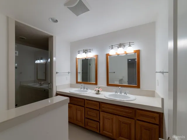 a bathroom with a sink double vanity and a mirror