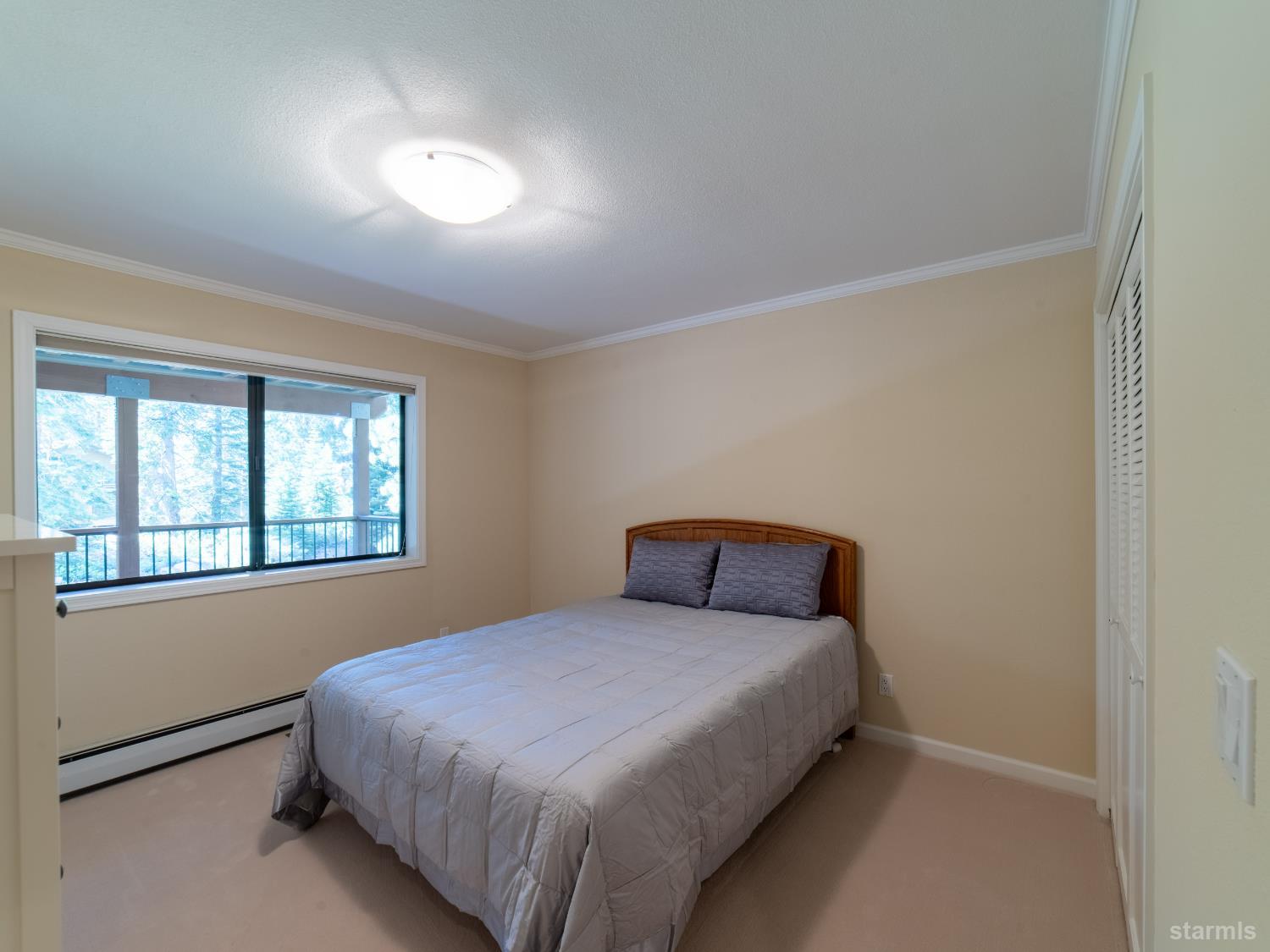 214 Uplands Way South Lake Tahoe, CA 96150 - Photo 10 of 27 a bedroom with a bed and a window