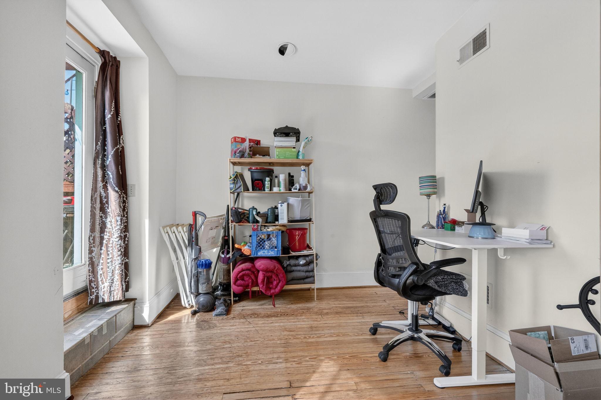 1944 Calvert Street Northwest Washington, DC 20009 - Photo 25 of 85 a view of a workspace with furniture and a window