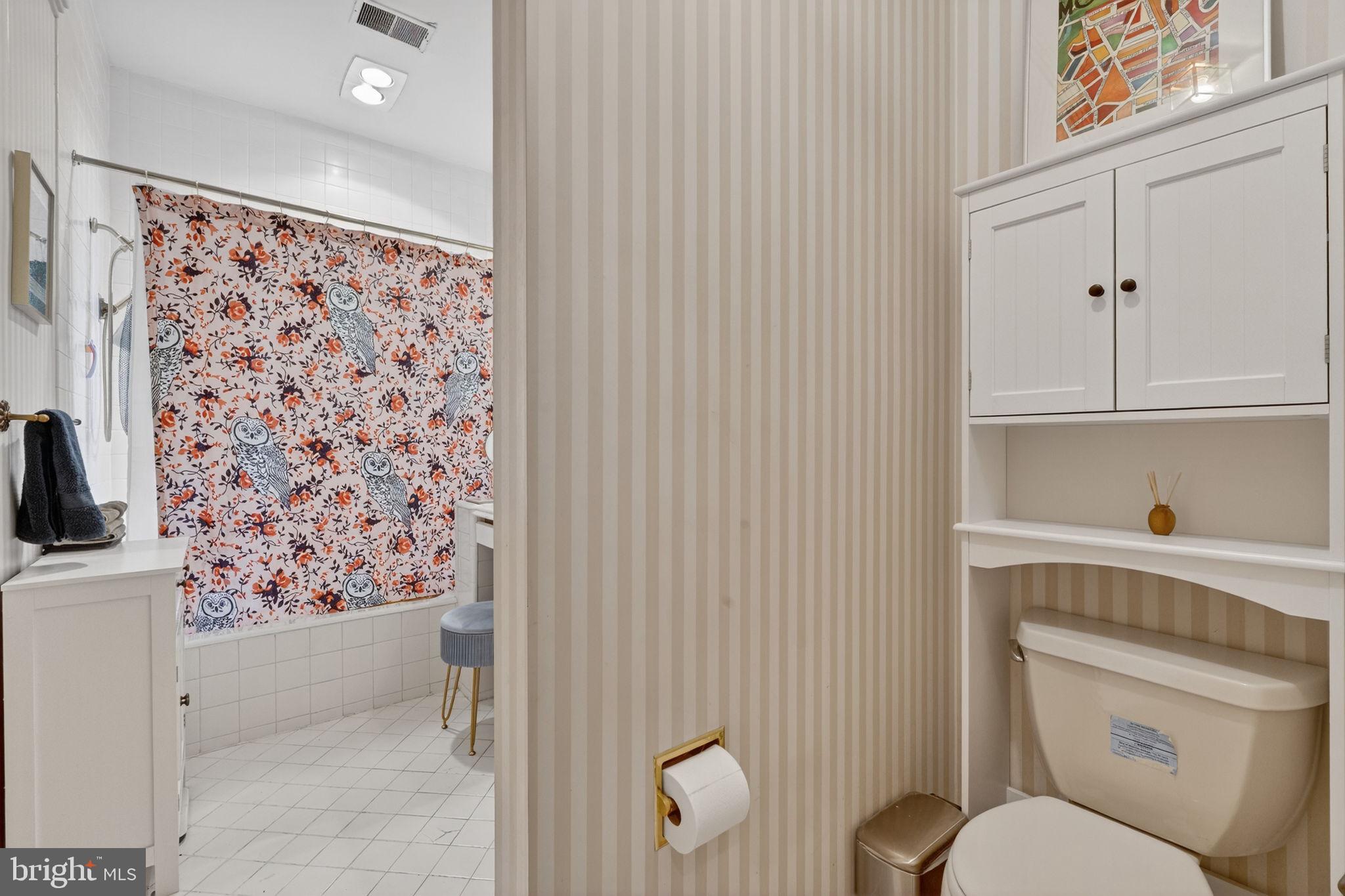 1944 Calvert Street Northwest Washington, DC 20009 - Photo 29 of 85 a bathroom with a toilet and a shower curtain