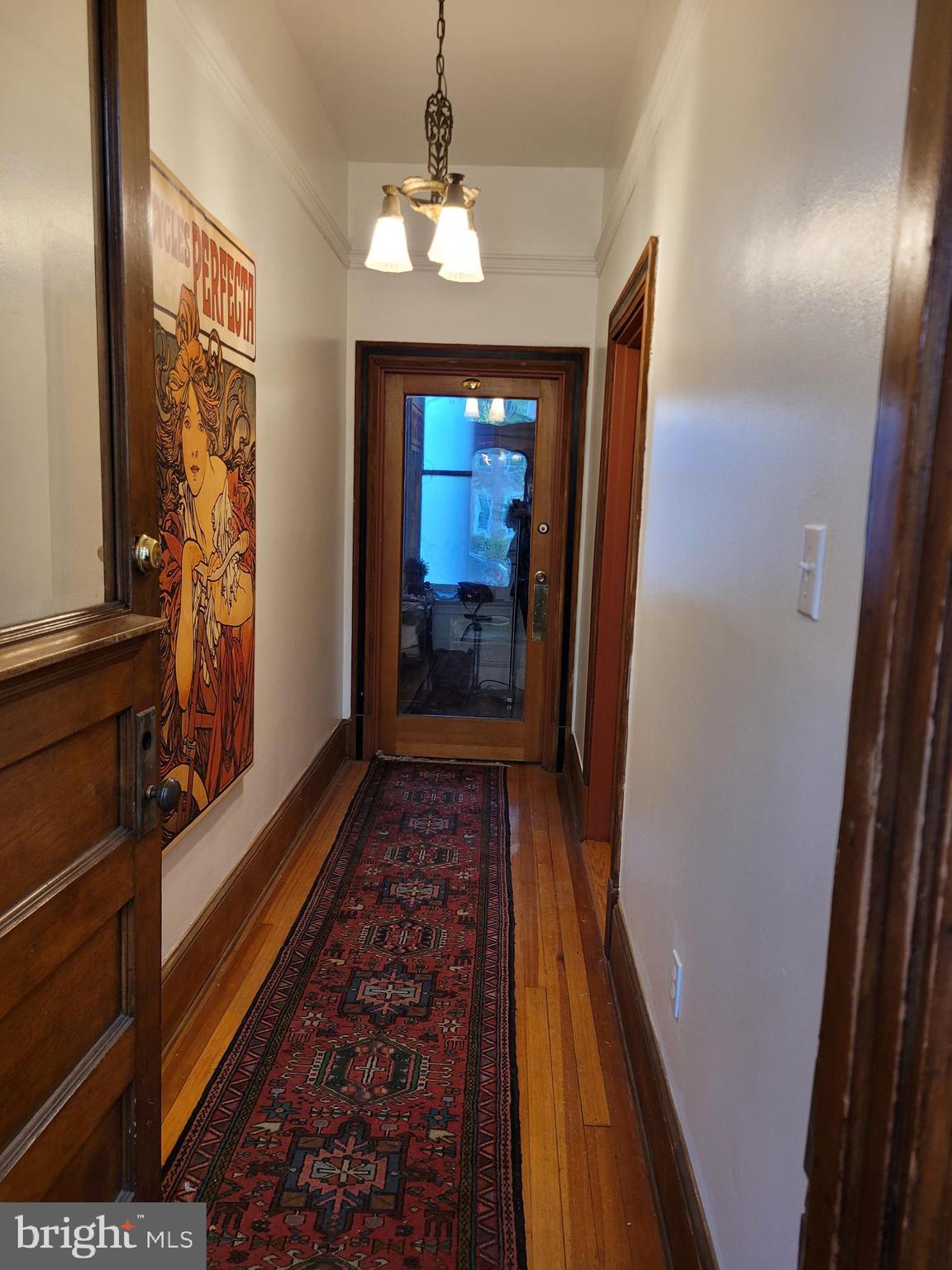 1944 Calvert Street Northwest Washington, DC 20009 - Photo 4 of 85 a view of a hallway view with wooden floor and staircase