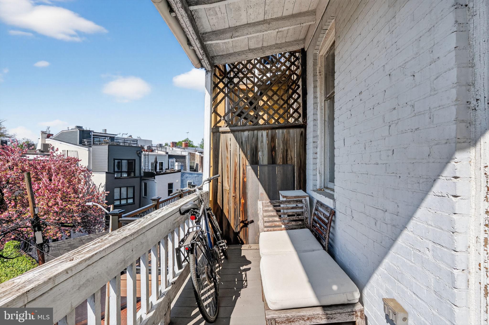 1944 Calvert Street Northwest Washington, DC 20009 - Photo 43 of 85 a view of balcony with wooden floor and city view