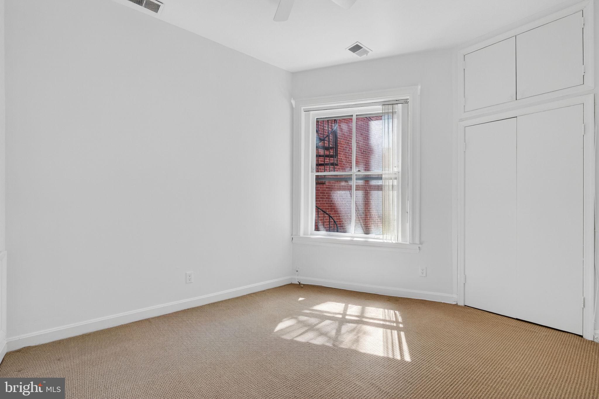 1944 Calvert Street Northwest Washington, DC 20009 - Photo 59 of 85 a view of an empty room with a window
