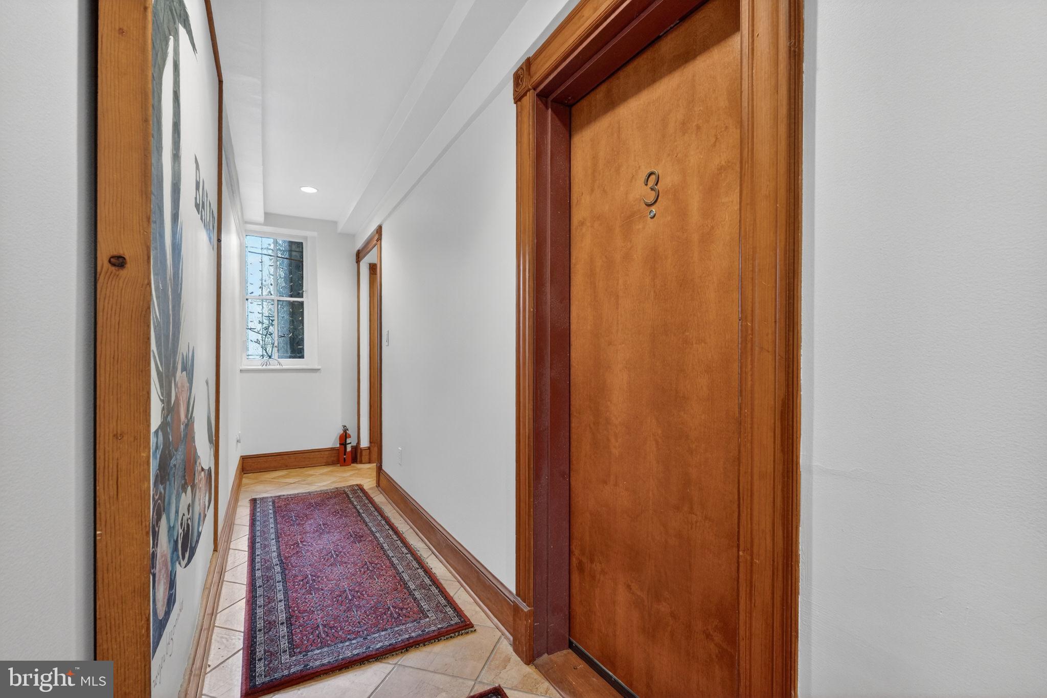 1944 Calvert Street Northwest Washington, DC 20009 - Photo 63 of 85 a view of a hallway with wooden floor and a bathroom