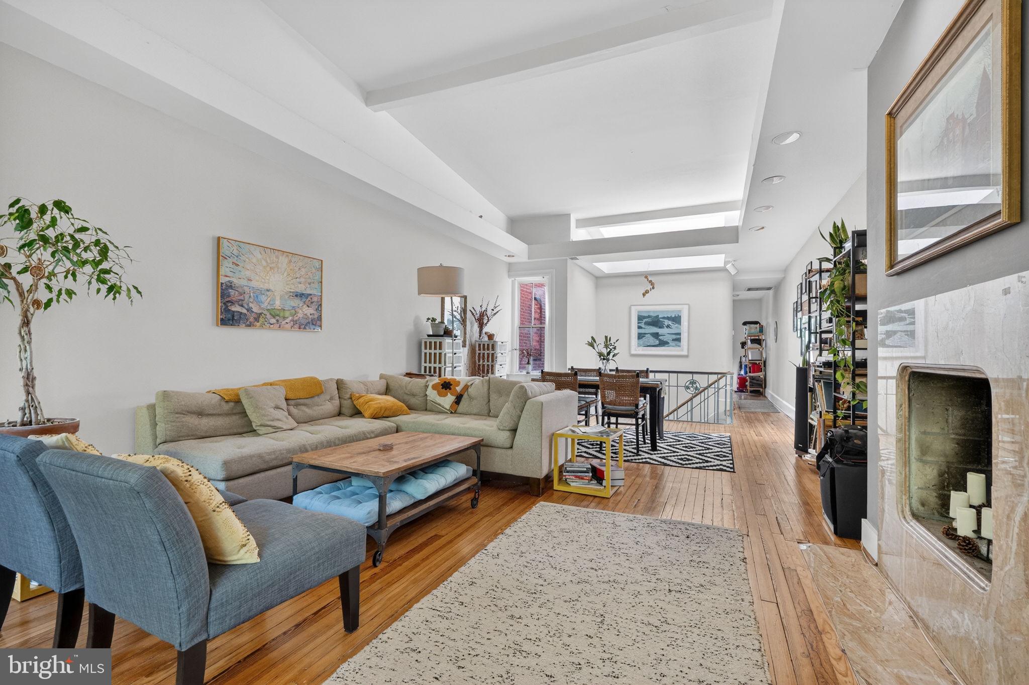 1944 Calvert Street Northwest Washington, DC 20009 - Photo 7 of 85 a living room with furniture a flat screen tv and a fireplace