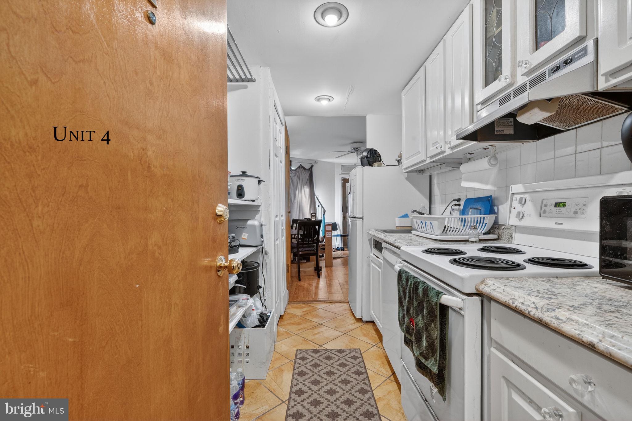 1944 Calvert Street Northwest Washington, DC 20009 - Photo 77 of 85 a kitchen with stainless steel appliances granite countertop a stove a sink and a refrigerator