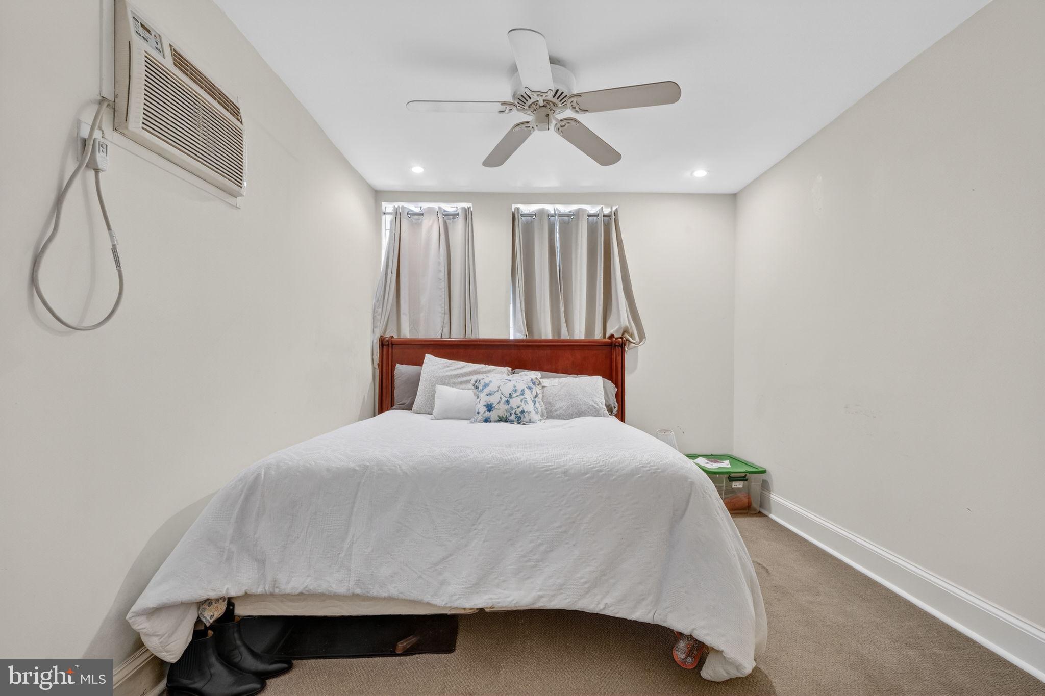 1944 Calvert Street Northwest Washington, DC 20009 - Photo 83 of 85 a bedroom with a bed and a ceiling fan