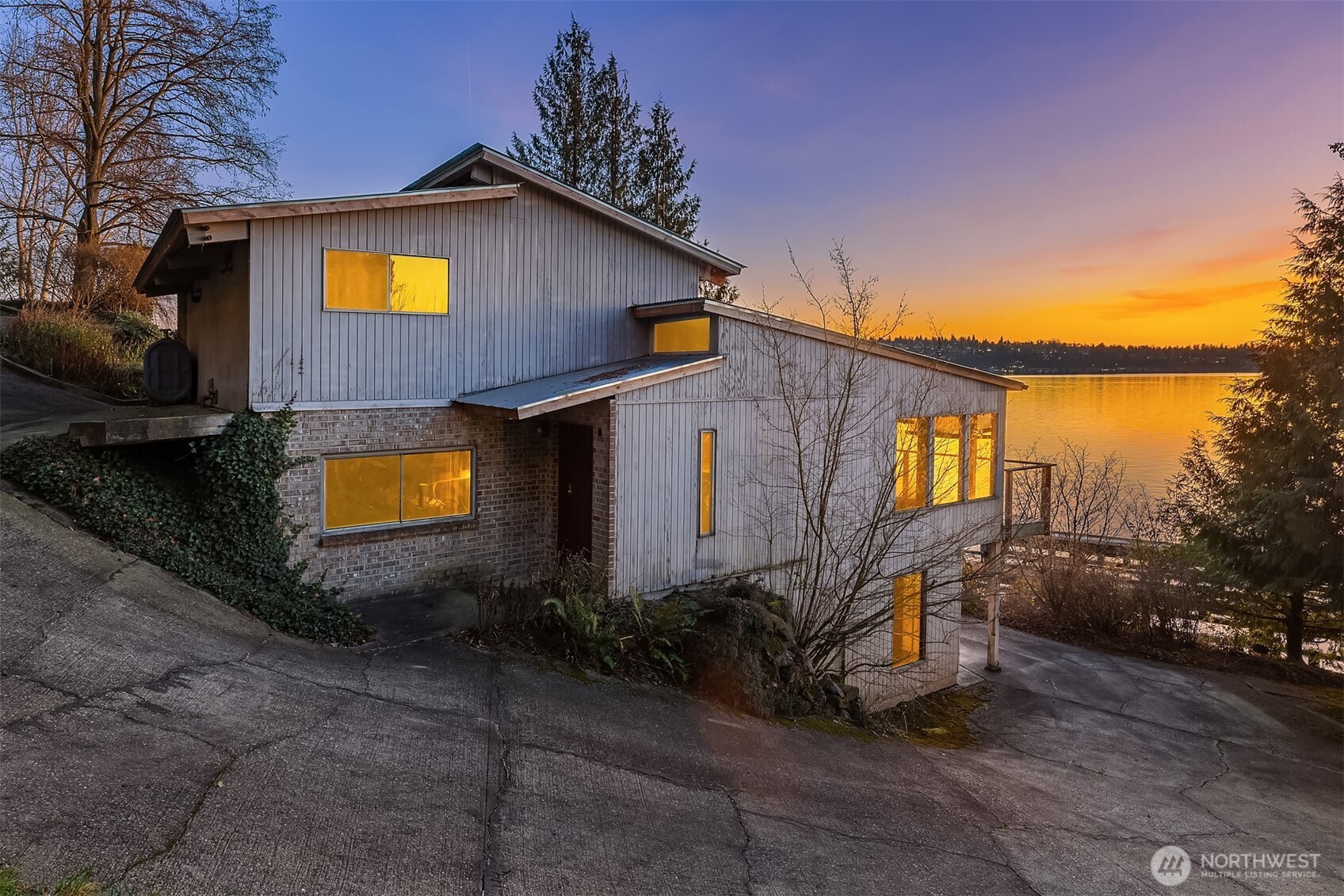 8001 West Mercer Way Mercer Island, WA 98040 - Photo 9 of 20 a yellow house with trees in front of it