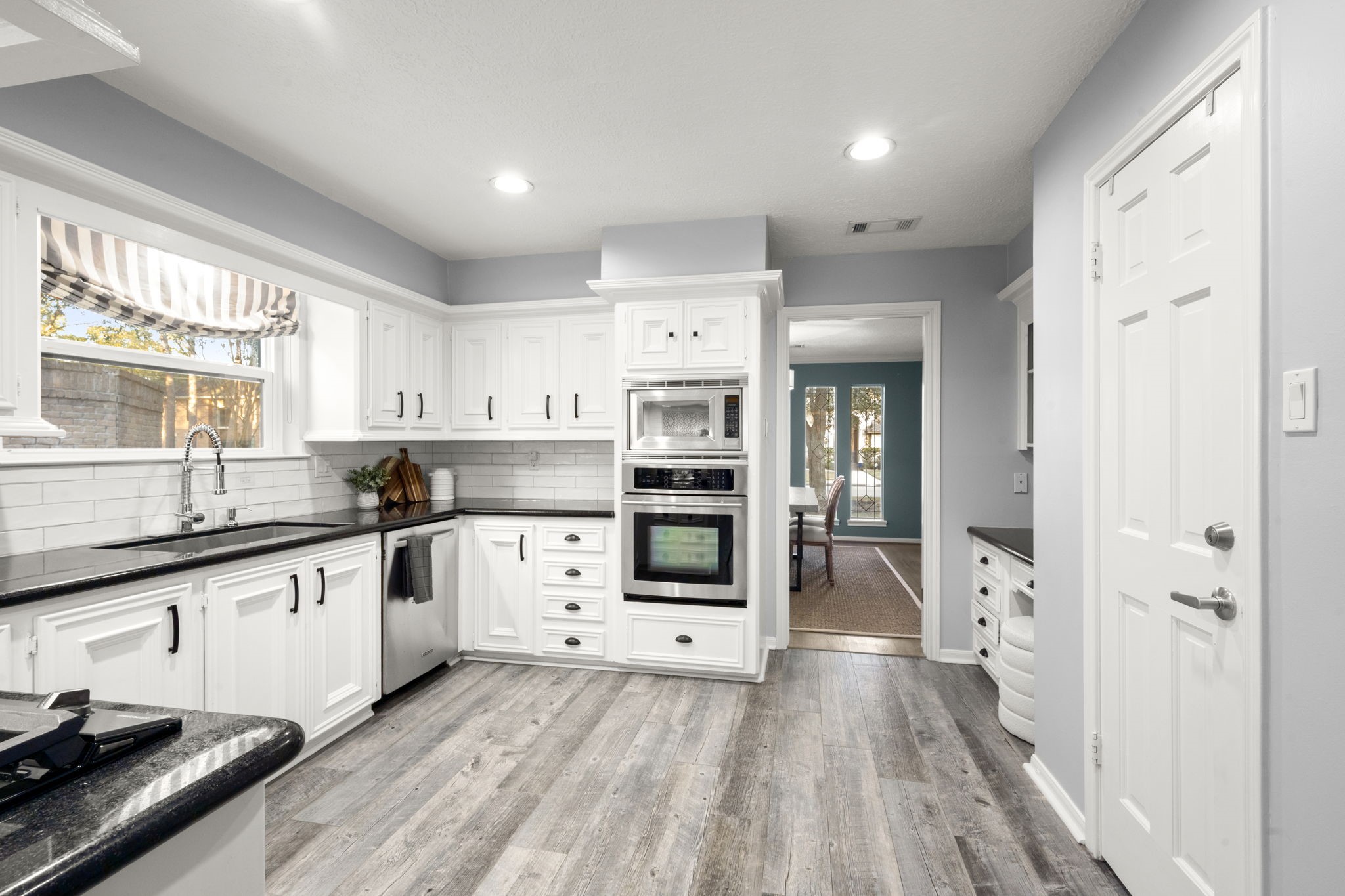 16111 Maplehurst Drive Spring, TX 77379 - Photo 10 of 30 a kitchen with granite countertop a stove and a sink