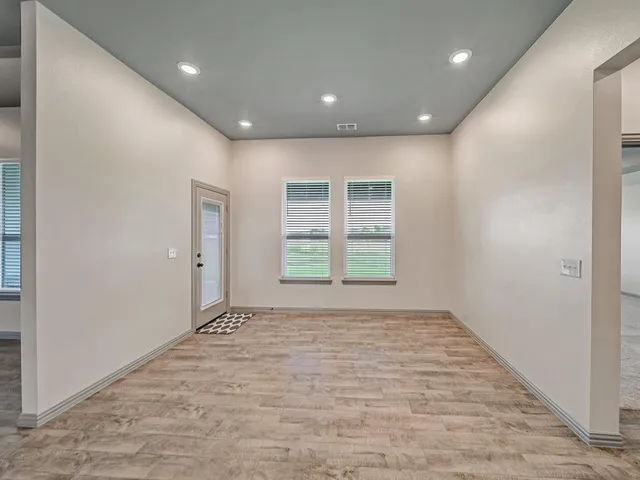 a view of an empty room with a window