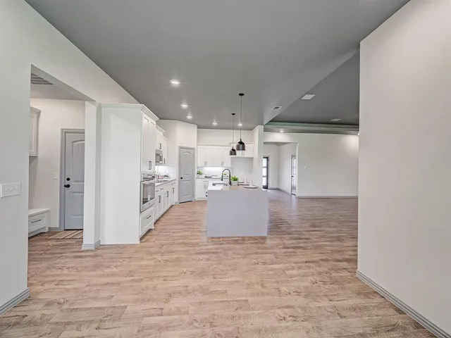 a view of kitchen and kitchen with a sink