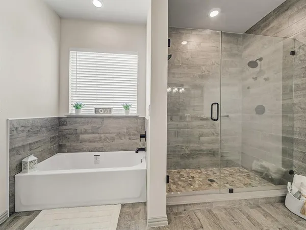 a bathroom with a bathtub and shower