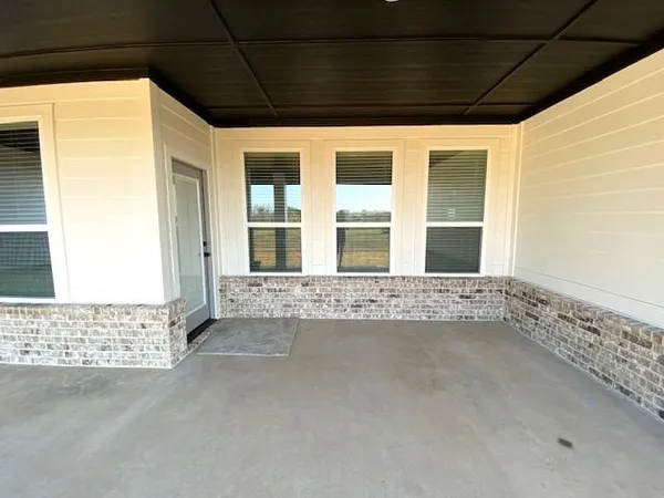 a view of an empty room with windows