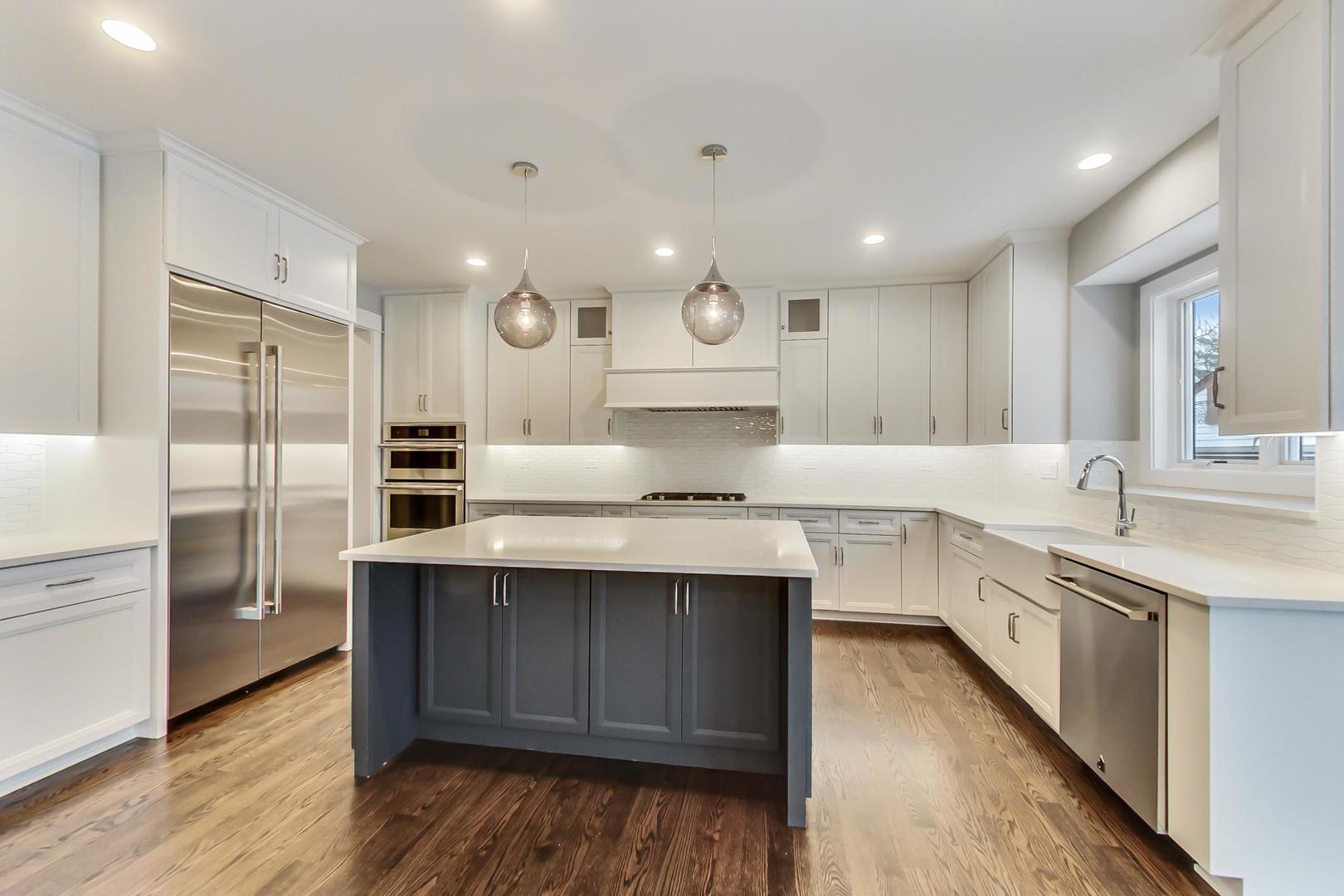 150 Avon Road Elmhurst, IL 60126 - Photo 3 of 18 a large kitchen with a sink and dishwasher stove a refrigerator a oven with wooden floors