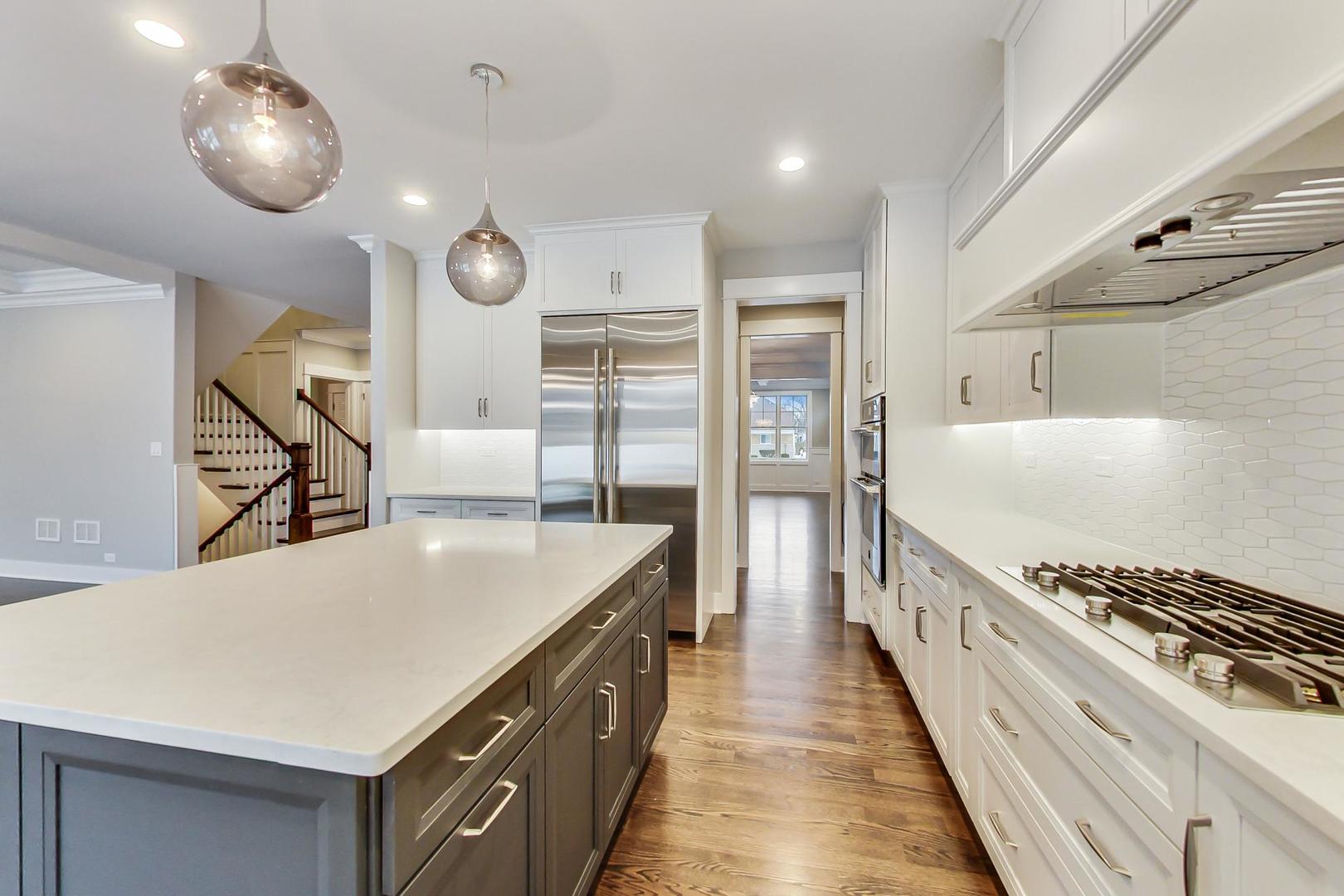 150 Avon Road Elmhurst, IL 60126 - Photo 4 of 18 a kitchen with counter top space and stainless steel appliances