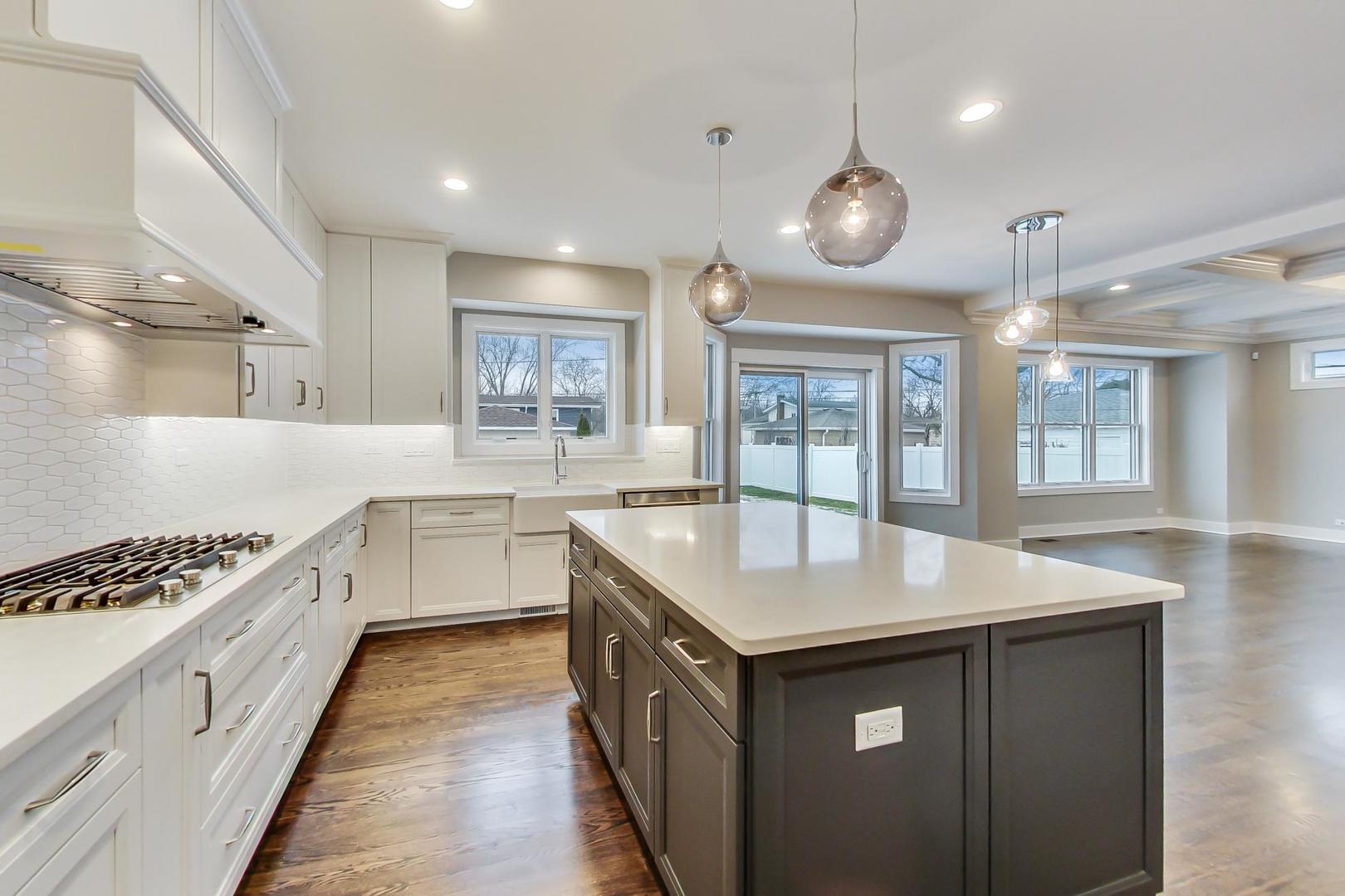 150 Avon Road Elmhurst, IL 60126 - Photo 5 of 18 a kitchen with a sink stove and cabinets