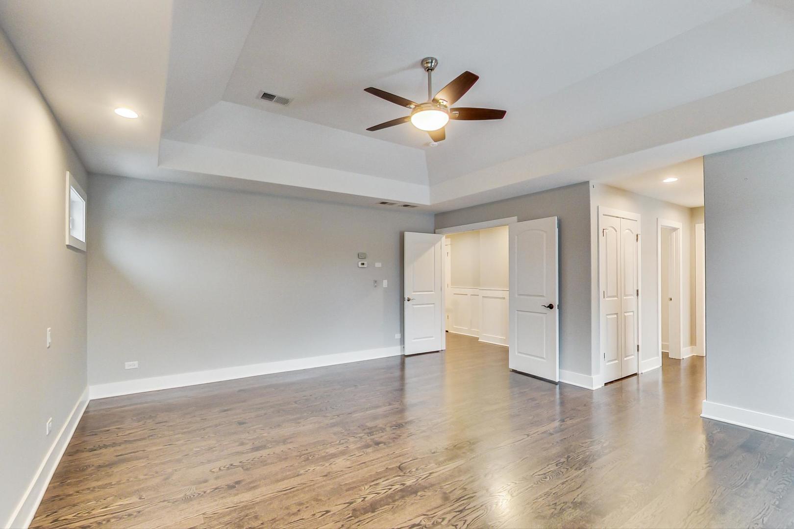 150 Avon Road Elmhurst, IL 60126 - Photo 8 of 18 a view of an empty room with wooden floor and a window