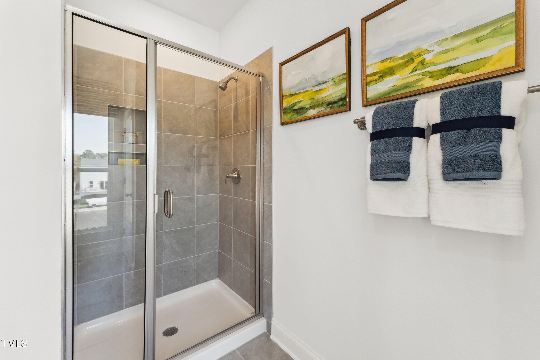 2906 Kempthorne Road Cary, NC 27519 - Photo 12 of 38 a bathroom with a shower and mirror