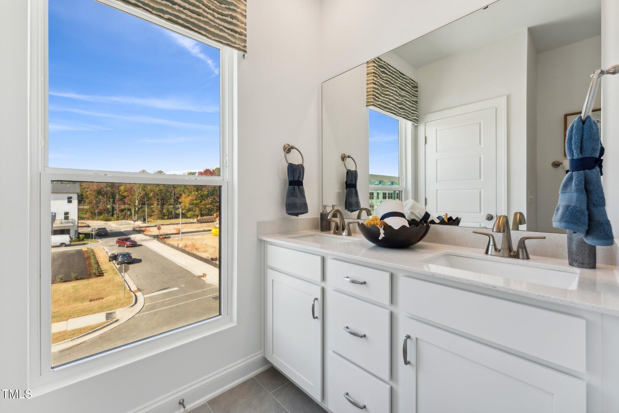 2906 Kempthorne Road Cary, NC 27519 - Photo 13 of 38 a bathroom with a double vanity sink and a window