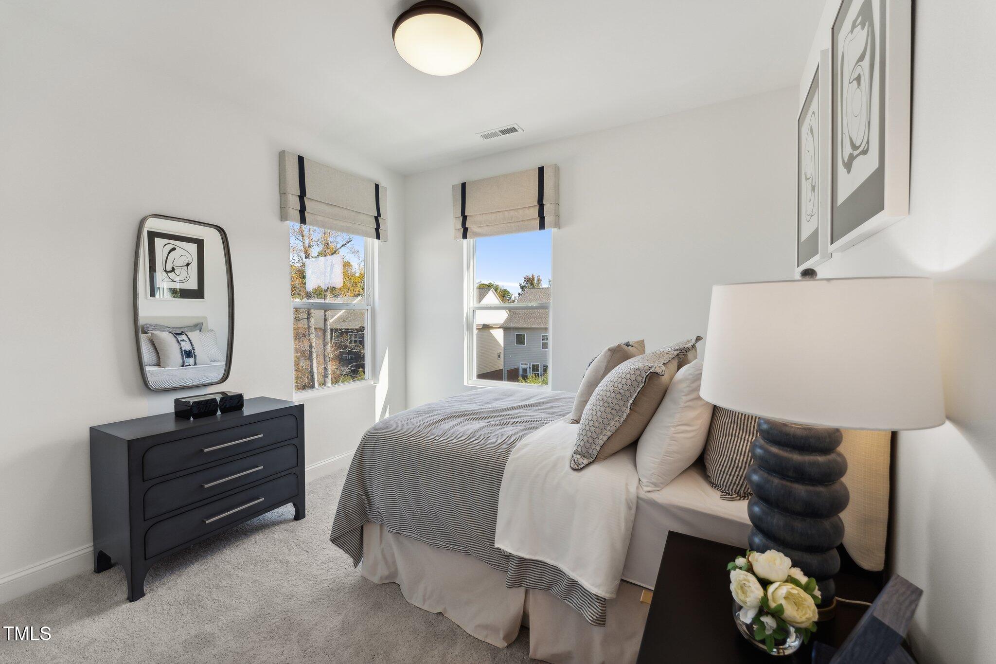 2906 Kempthorne Road Cary, NC 27519 - Photo 16 of 38 a bedroom with a bed and painting on the wall